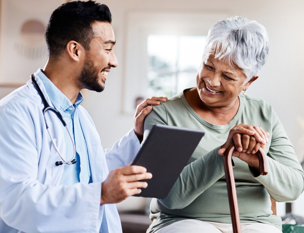 Shot of a young doctor sharing information from his digital tablet with an older patient conducting diabetes stigma research