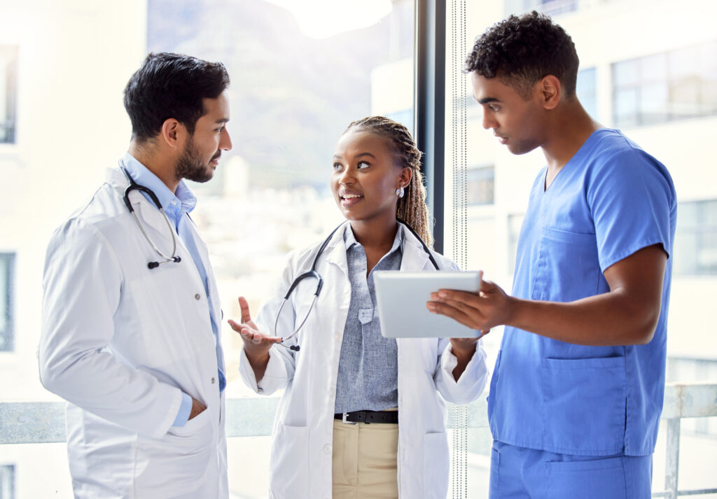 Shot of a group of doctors using a digital tablet at work research on stigma from healthcare professionals