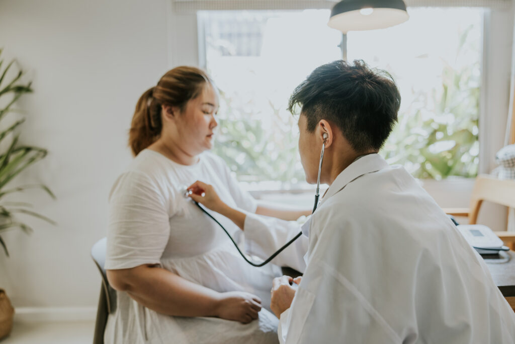 doctor doing medical exam to obesity patient at home, medical service and conducting weight stigma research