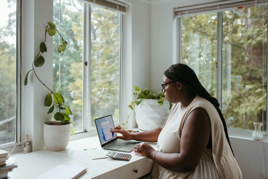 Black woman writing at her computer